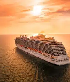 white ship on sea during sunset